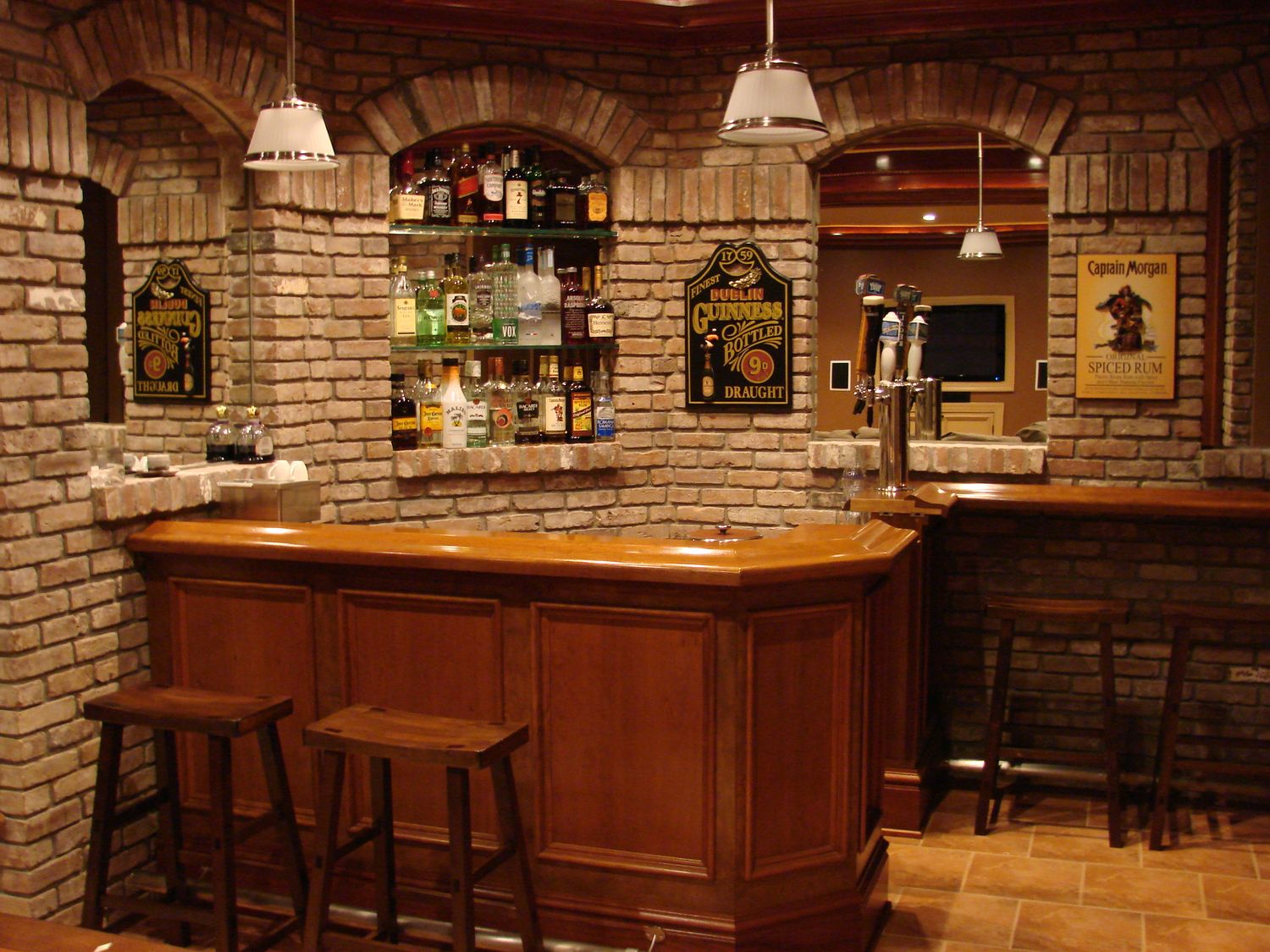 Custom home bar with wood top and brick arch surround built by Division Seven Millwork