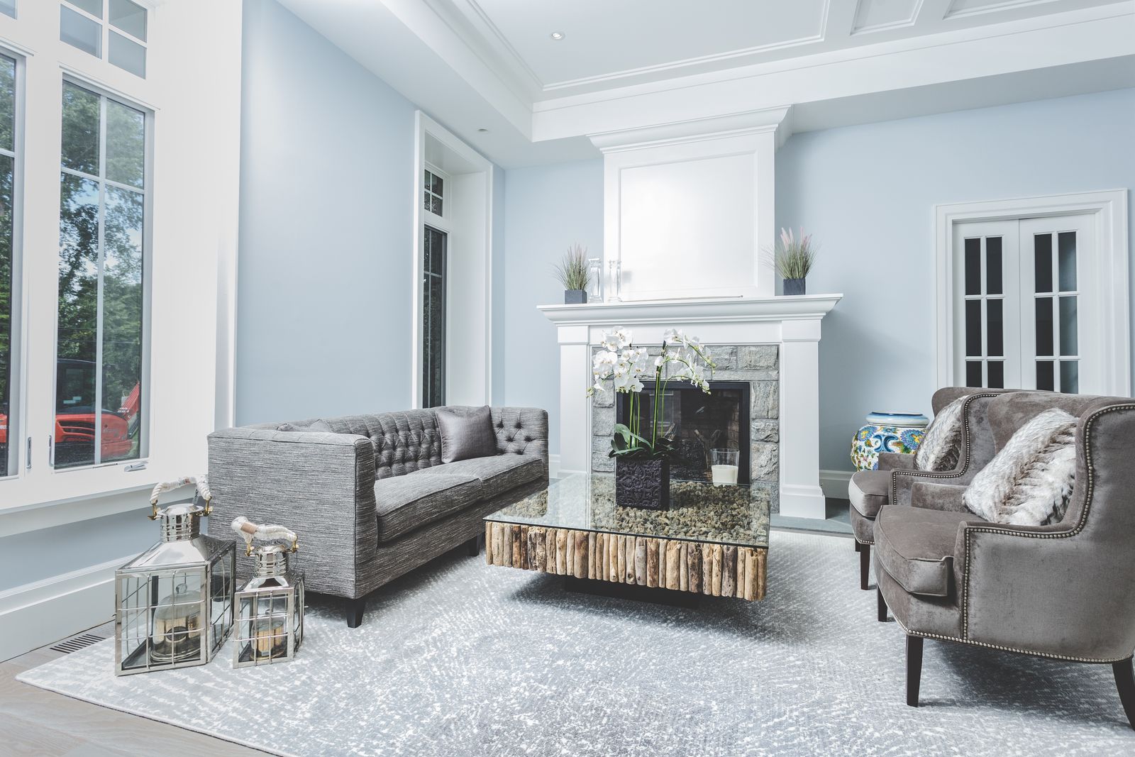 Living room with custom fireplace mantel and coffered ceiling millwork by Division Seven Millwork